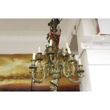 Lighting: Late 19th century brass nine-branch chandelier, the reeded column and scrolled bird cage