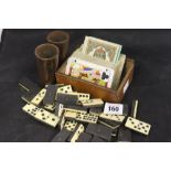 19th cent. Games: Incomplete set of bone and ebony domino's, bamboo dice shakers a pair, 2 x packs