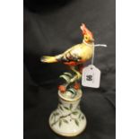 19th cent. Porcelain figure of a crested bird on a branch. Italian, indistinct signature. 9¼ins.