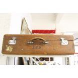 Luggage: Tan leather suitcase fitted with straps. 27ins. x 18ins. x 6ins.