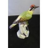 19th/20th cent. European Ceramics: Meissen figure of a green woodpecker perched on a tree stump,