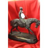 20th cent. Cast bronze figure of a horse and rider "Bonheur", on a slate plinth. 15¾ins high.