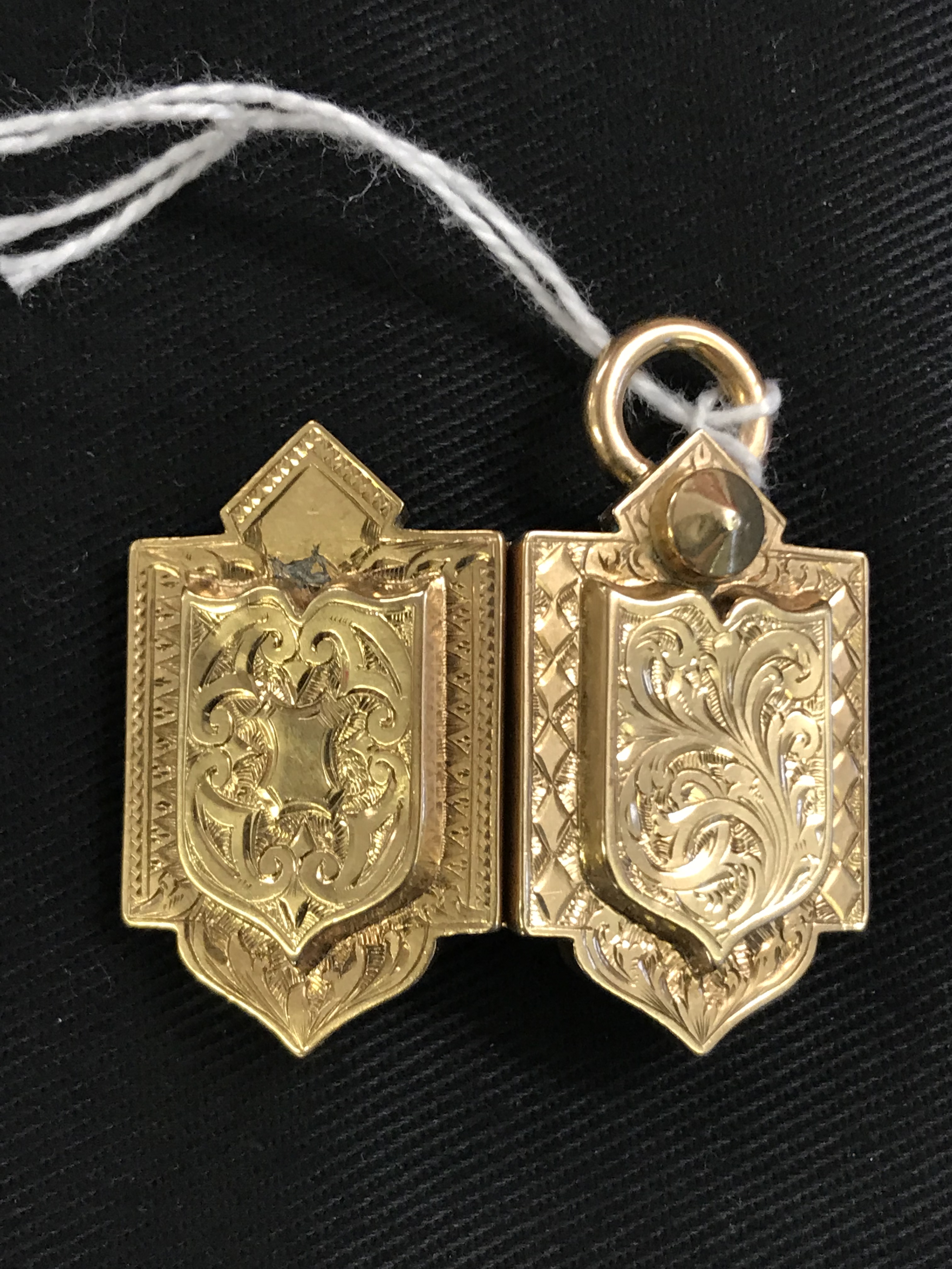 19th cent. Yellow Metal Jewellery: Gothic style floral engraved locket, opens to reveal 2 oval