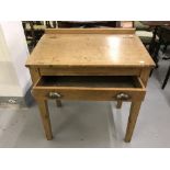 20th cent. Pine desk with single drawer below a sloping cover. The whole on square tapering