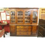19th cent. Flame mahogany bookcase, glazed 4 door case. The whole rising off a plinth. 77ins. x