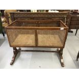 Late 19th/early 20th cent. Mahogany swing crib with rattan sides, central turned column.