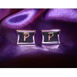 Elvis Presley: Superb pair of white and enamel metal owned and worn cufflink's bearing the