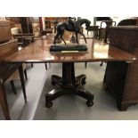 Early 19th cent. Mahogany tilt top dining table, a single pedestal on quadruped base with