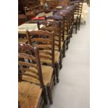 Late 19th cent. oak ladder back dining chairs, rush seated, harlequin set of 8 plus 2 carvers. (