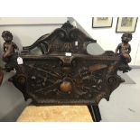 20th cent. Stained and polished hardwood. A deep carved furniture frieze with cherubs, ribbons,