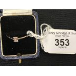 Diamond Jewellery: Solitaire set baguette cut approx. .20ct. shank hallmarked 18ct. white gold.