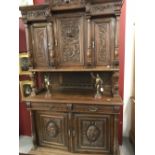Early 20th cent. Oak continental heavily carved dresser. The base having two drawers over a two door