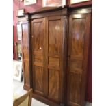 19th cent. Flame mahogany breakfront compactum, both end sections with shelves, the central