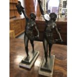 Early 20th cent. Spelter figures holding grapes, some damage, both on marble plinths - a pair