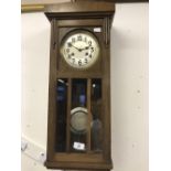 Clocks: 20th cent. Wall clock, oak cased. 10½ins x 24ins x 6ins.