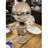 Late 19th/early 20th cent. Glass oil lamp, base and globe decorated with rustic winter scenes.