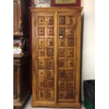20th cent. Indonesian hardwood hall cupboard, with two doors and two shelves. The panels have