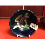 20th cent. Ceramics: Moorcroft footed bowl, orchid on dark blue ground. 4½ins x 4ins.