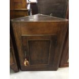 19th cent. Oak wall mounted corner cupboard, 3 shelves single, solid door 23ins. x 29ins. 12½ins.