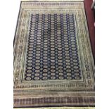 20th cent. Machine made Turkish rug (with lead seal). Dark blue ground, nine borders, central