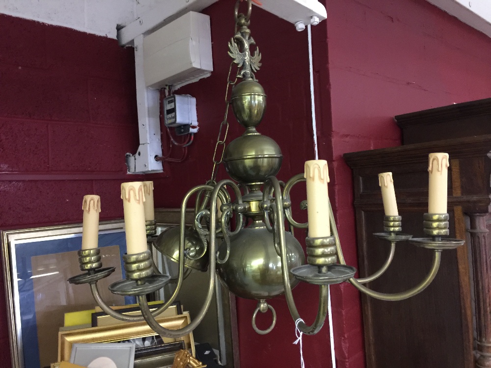 20th cent. Lighting: Brass eight branch chandelier. Three central orbs and crowned with two