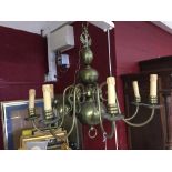 20th cent. Lighting: Brass eight branch chandelier. Three central orbs and crowned with two