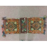 Carpets/Rugs: 20th cent. Hand loom carpet, saddle bags, red ground, central medallion, single border