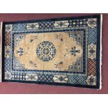 Rugs: Modern weave washed Eastern style carpet, beige ground, blue surround, stylised geometric