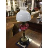 19th cent. Oil lamp, black glass base, brass column, cranberry glass reservoir, with flue and