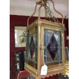 20th cent. Lighting: Gothic style brass hall lantern with stained glass panels. 22ins. rectangular