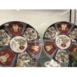 Japanese Imari chargers, with floral motifs to fan shaped panels, central motif depicts flowers.