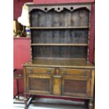 20th cent. Oak dresser: The base has two drawers and a two door cupboard with square on turned