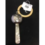 Hallmarked Silver: Baby's rattle/bone teething ring, with mother of pearl handle, embossed teddy
