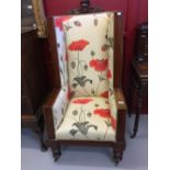 19th cent. Wingback chair upholstered in a contemporary style with poppy floral motifs. The chair