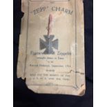 Military WWI: Zeppelin charm on a display card. The V.C. Cross shape is shaped from the framework of