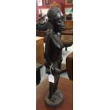 20th cent. Ebony figure of an African native woman with sticks and drinking vessel with a child
