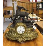 Clocks: Table clock in gilt metal and spelter, mounted with a stag hunt scene. The movement, Japy