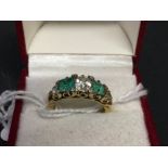 Diamond & Emerald Jewellery: Boat shaped ring, centre stone ·75 plus two others ·10, emeralds cut