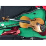 20th cent. Violin in case, with accessories. Length 23½ins.