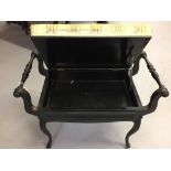 Early Edwardian ebonised piano stool. Carved serpentine supports, upholstered seat opening to reveal