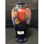 Moorcroft - The Newman Collection: c1925 Tall vase decorated with the pomegranate design on the blue