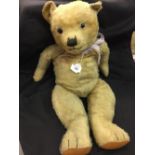 Toys: Teddy bear, early 20th cent. Brown glass eyes, replacement foot pads. In need of love. 23ins.