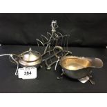 Hallmarked Silver: Small sauce boat, mustard pot and cover, and a four slice toast rack.