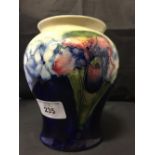 Moorcroft - The Newman Collection: c1935 Blue ground baluster shaped vase in the orchid pattern, 5½