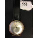 Watches: Gents Enicar gold wrist watch with black strap.