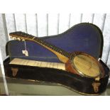 Musical Instruments: Six string mini banjo, treen body, with carrying case.