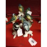 Karl Ens bird figures. Blue tit family, four birds on a branch. A single blue tit (small chip to