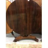 20th cent. Rosewood, circular tilt top dining table on a single pedestal, with carved tripod