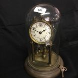 Clocks: 20th cent. Anniversary clock mounted on a plinth and under a glass dome.