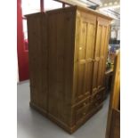 20th cent. Pine double wardrobe with storage beneath, 2 short drawers over 2 long drawers. 42¼ins. x